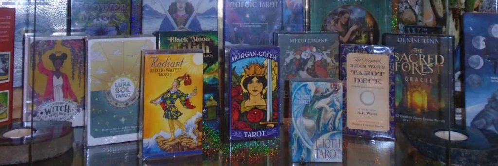 mixture of tarot and oracle cards including black moon lillith and sacred forest oracle, tarot forhaxe, morgan greer, radiant and rider waite, crowley thoth, lunar sol and modern witch tarot deck sets.