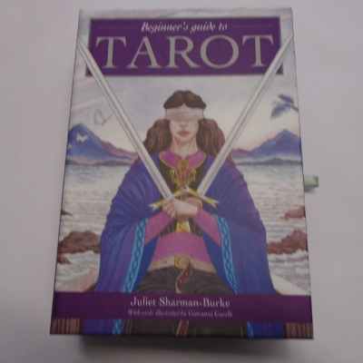 Boxed set of Beginners Guide to Tarot by Juliette Sharman-Burkem lllustrated by Giovani Caselli. Box front shows illustration of 2 of Swords card - A seated and blindfolded woman holding 2 swords, one in each hand, points upward