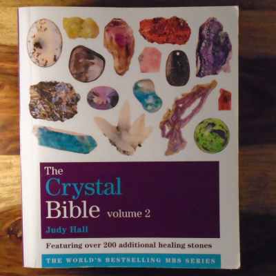 A soft cover copy of the Crystal Bible volume 2 by Judy Hall (featuring over 200 additional healing stones)