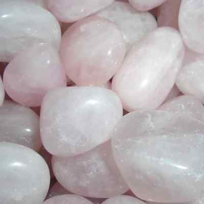 a close up of pale pink rose quartz tumblestones